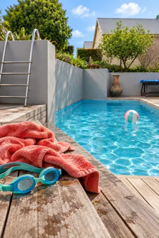 Moxie House — Summer pool with towel and swimming goggles