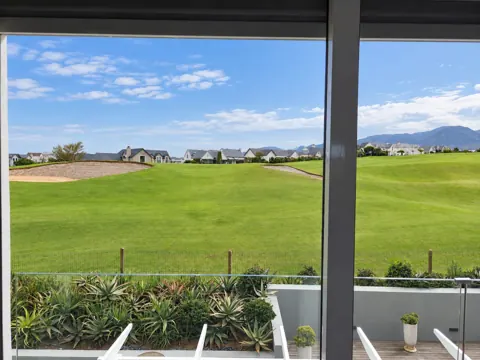 Moxie House — Large windows framing the fairway outlook