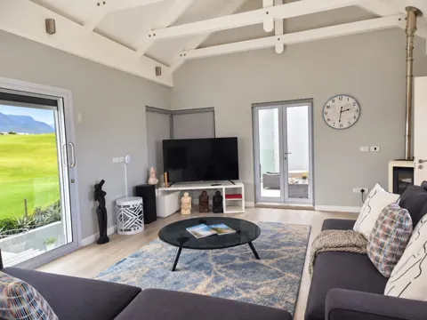 Moxie House — Upstairs lounge with glass coffee table