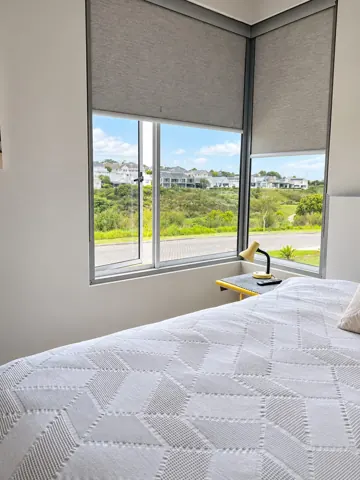 Moxie House — White bedding and leafy window outlook