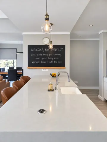Moxie House — White kitchen island and welcome board