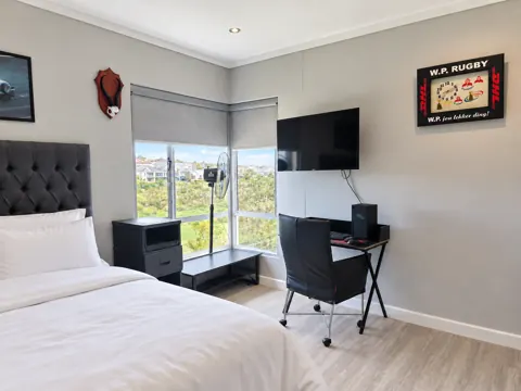 Moxie House — Freshly made double bedroom with workspace